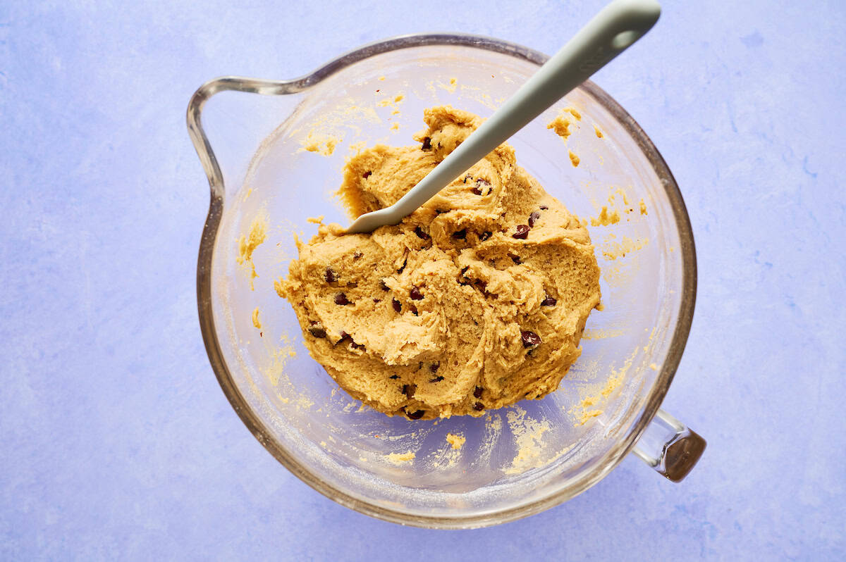 cooking dough with chocolate chips in a mixing bowl