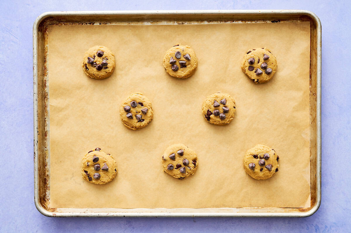 sugar free cookies formed and topped with chocolate chips ready to be baked