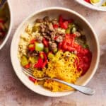 an assembled stuffed pepper bowl topped with shredded cheese