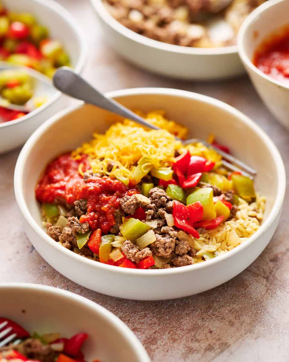 an assembled stuffed pepper bowl topped with shredded cheese