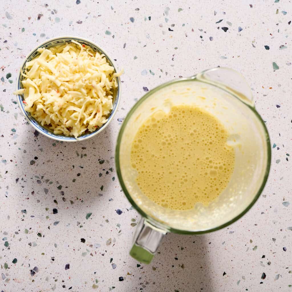 folding cheese into the egg mixture after blending
