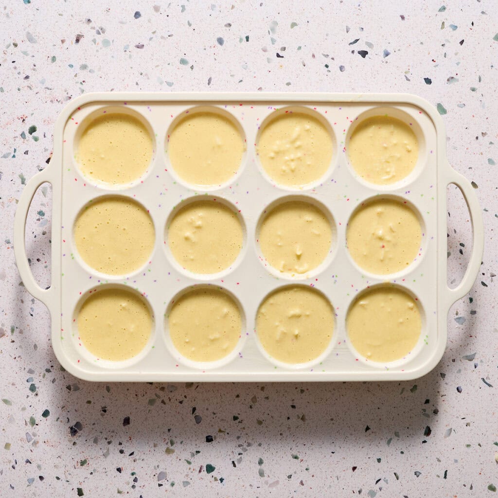 egg mixture blended with shredded cheese in a bowl on the side