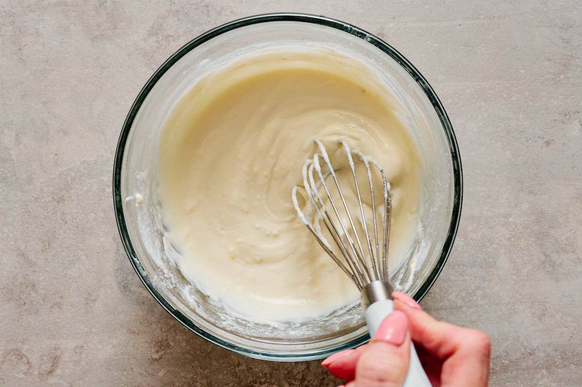 ricotta with galic and olive oil being whisked in preparation for plating