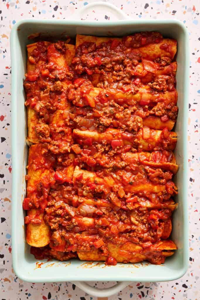 enchiladas topped with leftover sauce and beef
