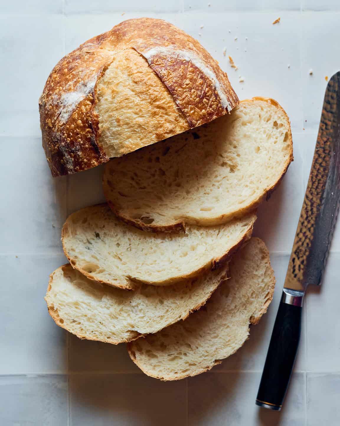 a loaf of sourdough bread sliced ith slices fanned out