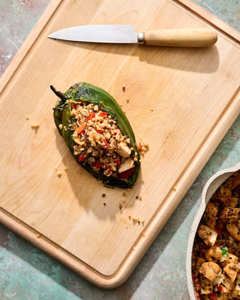 a single pepper that's been prepared and stuffed on a cutting board