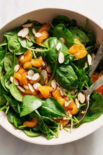 salad served in a large bowl with tongs