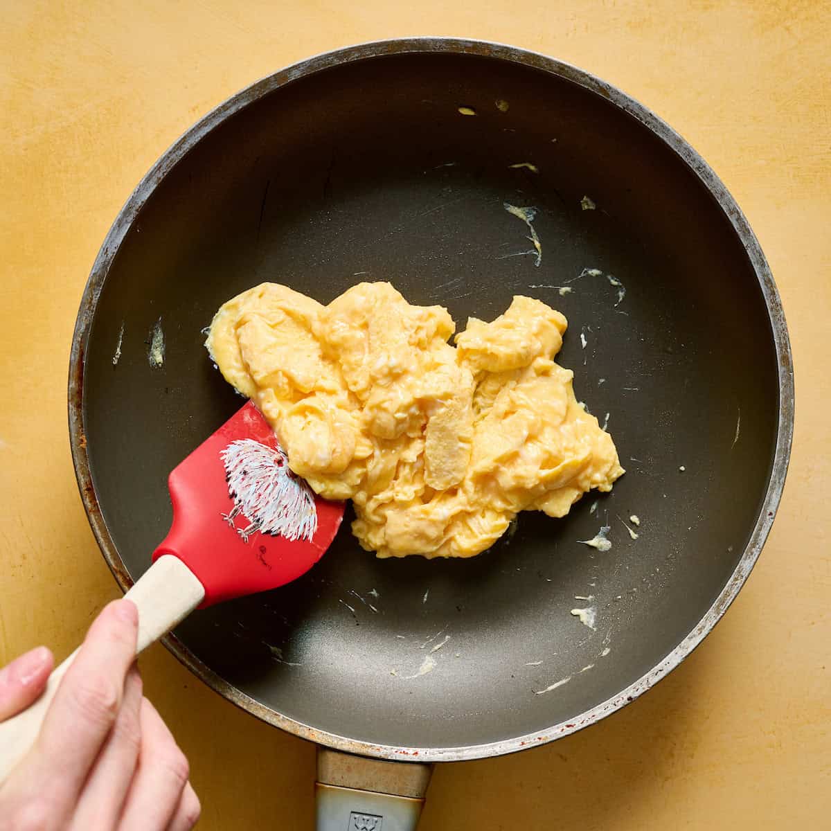 scrambling eggs in a skillet
