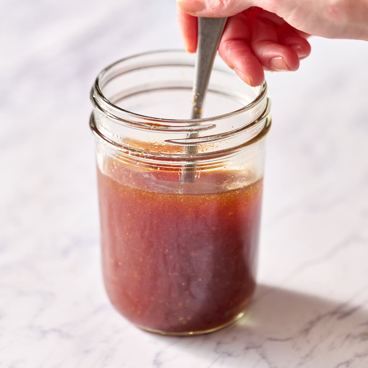 whisking the dressing ingredients in a mason jar