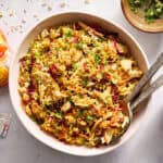 ramen noodle salad in a large serving bowl with tongs