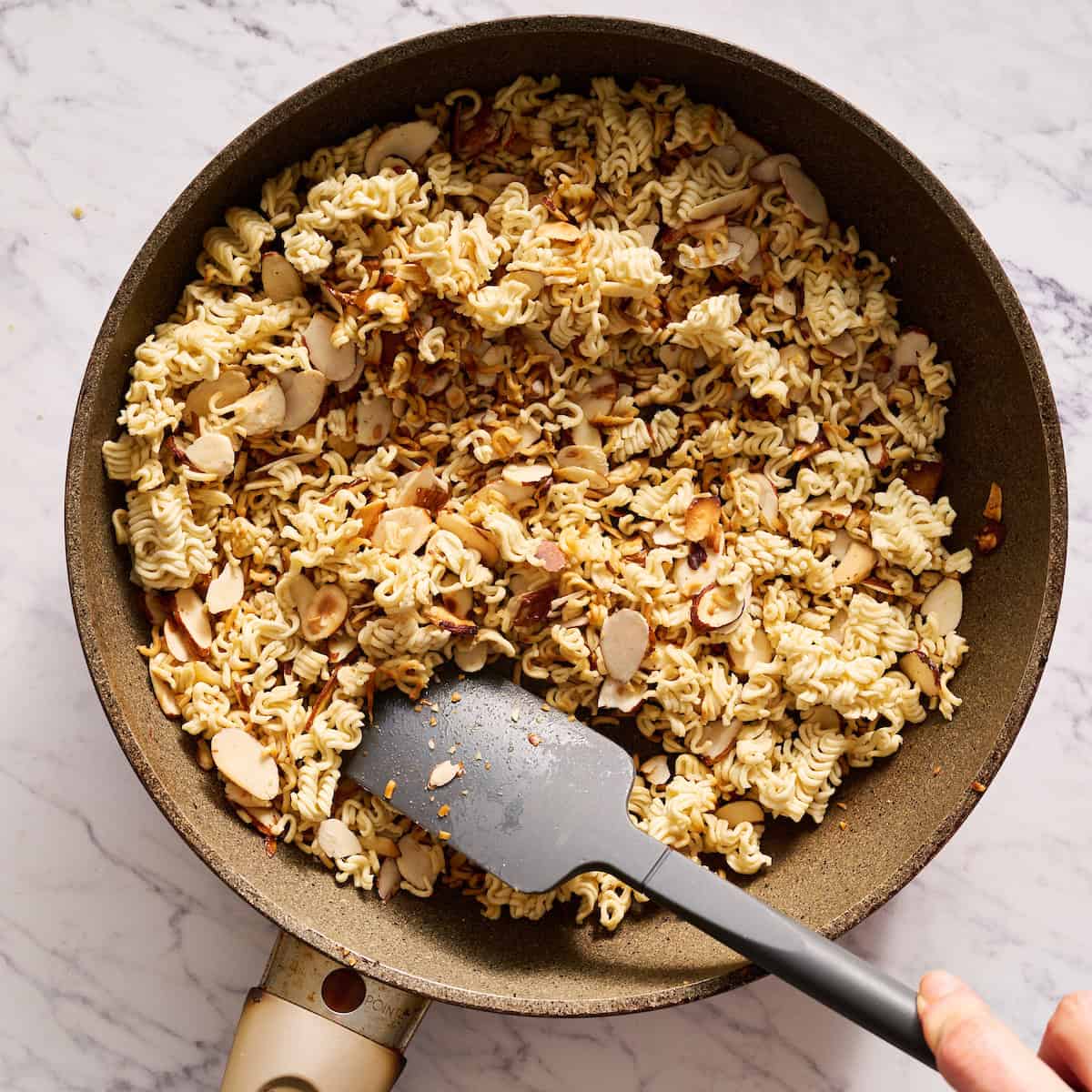 toasting the noodles and almonds in a saute pan with butter