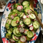 radish and cucumber salad tossed in a bowl