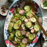 radish and cucumber salad tossed in a bowl