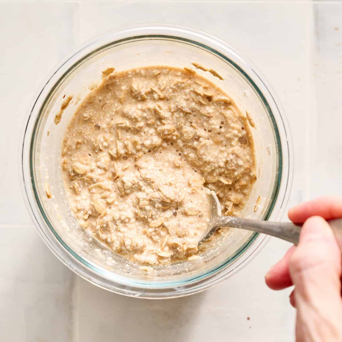 stirring oats with other ingredients in a bowl