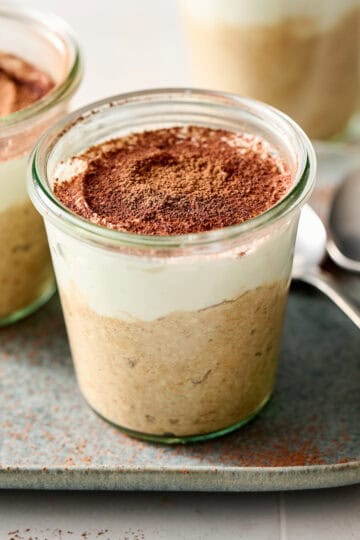 tiramisu overnight oats with ricotta in jars with cocoa powder on the side