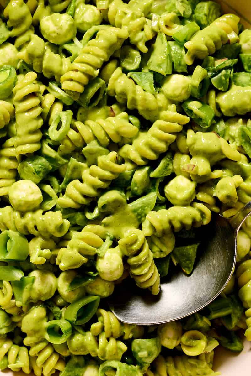 extreme closeup of pasta salad with basil lime dressing