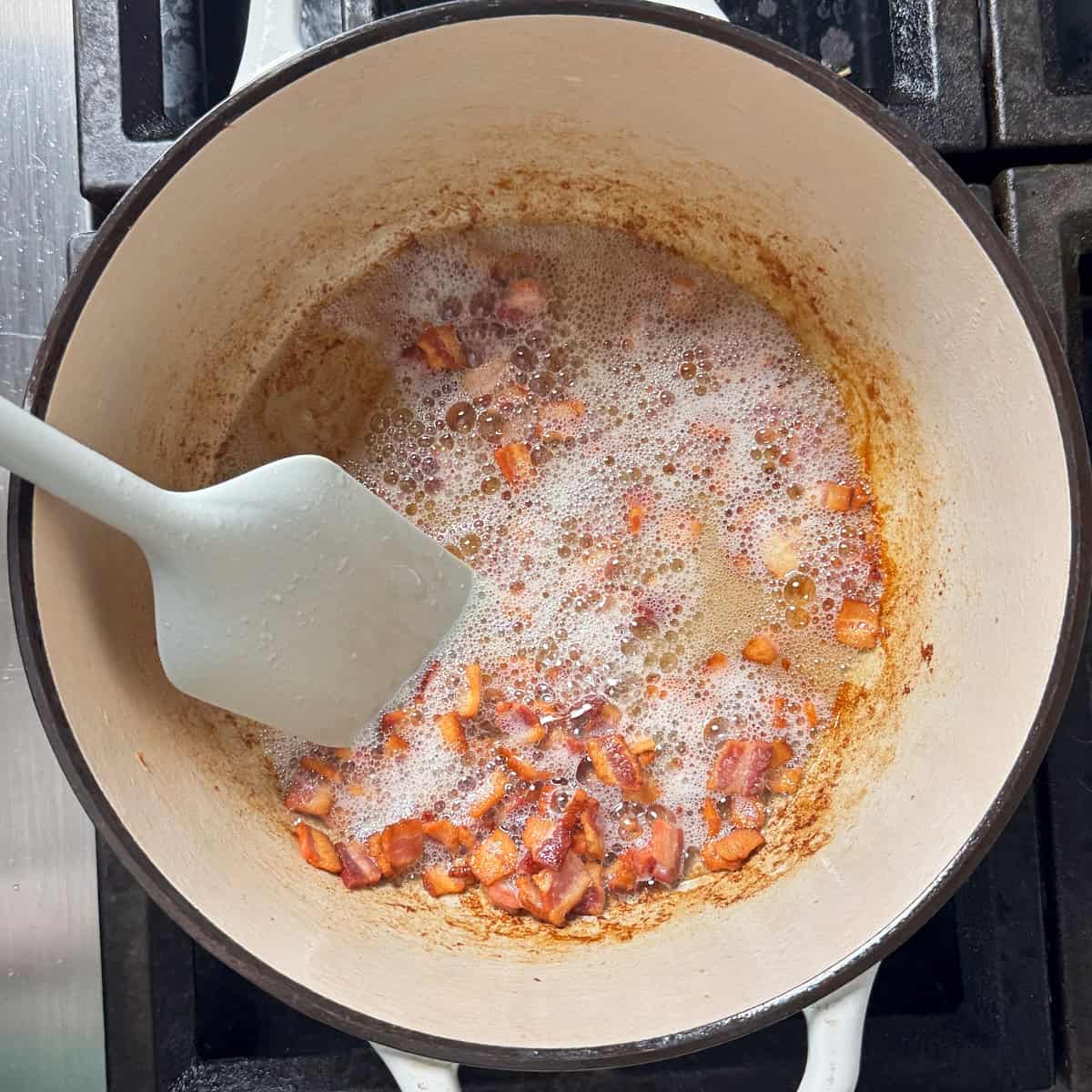 frying bacon bits in a stock pot