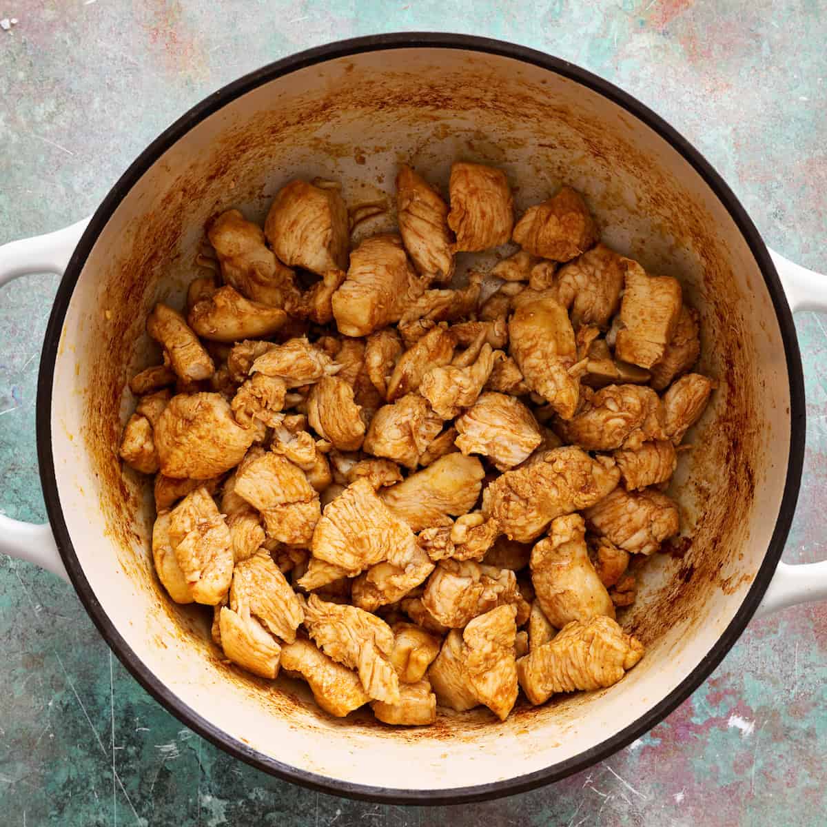 browning the chicken in a pot