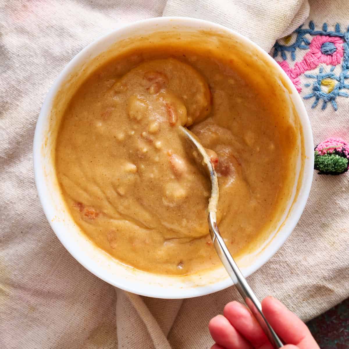 stirring together the masa and liquids from the pot
