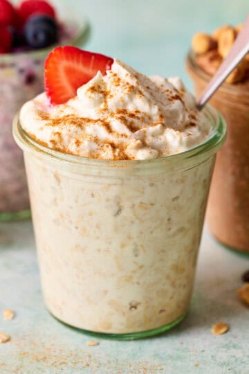 a jar of overnight oats made with cottage cheese topped with greek yogurt and berries