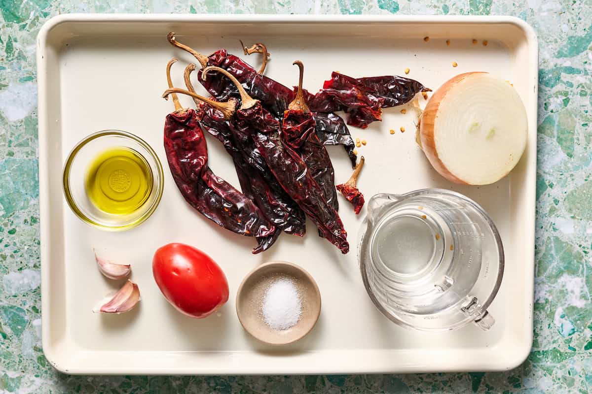 ingredients to make homemade enchilada sauce including dried chili pods