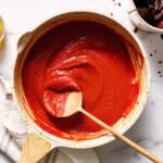 finished sauce in a saute pan with splatters after simmering