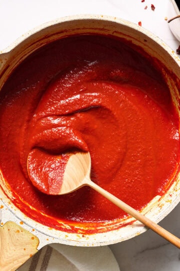 finished sauce in a saute pan with splatters after simmering