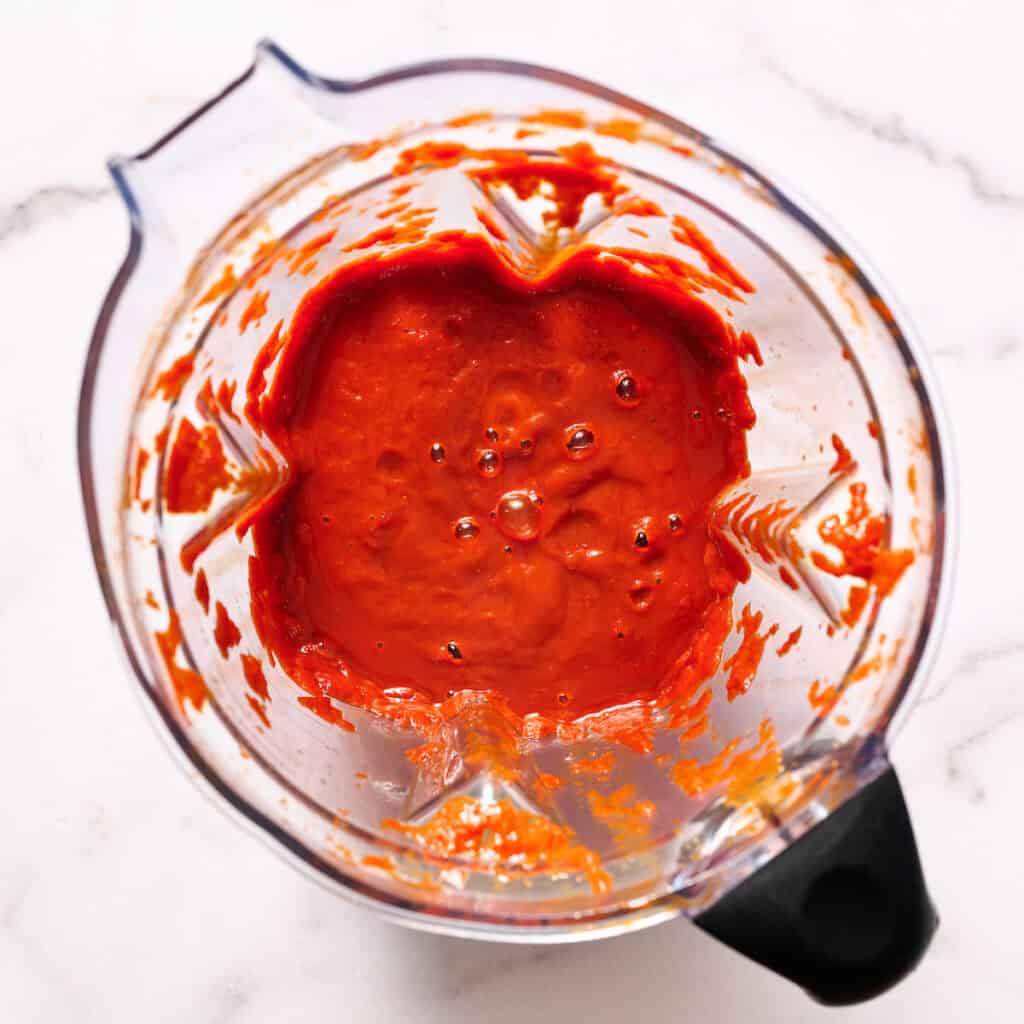 blended sauce inside a blender, red and smooth