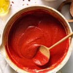 Finished sauce in a saute pan with dried chilies on the side