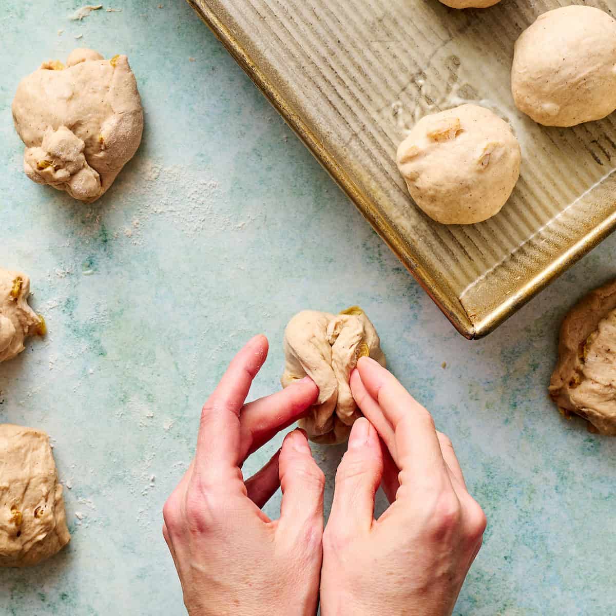folding dough ball to create a formed roll