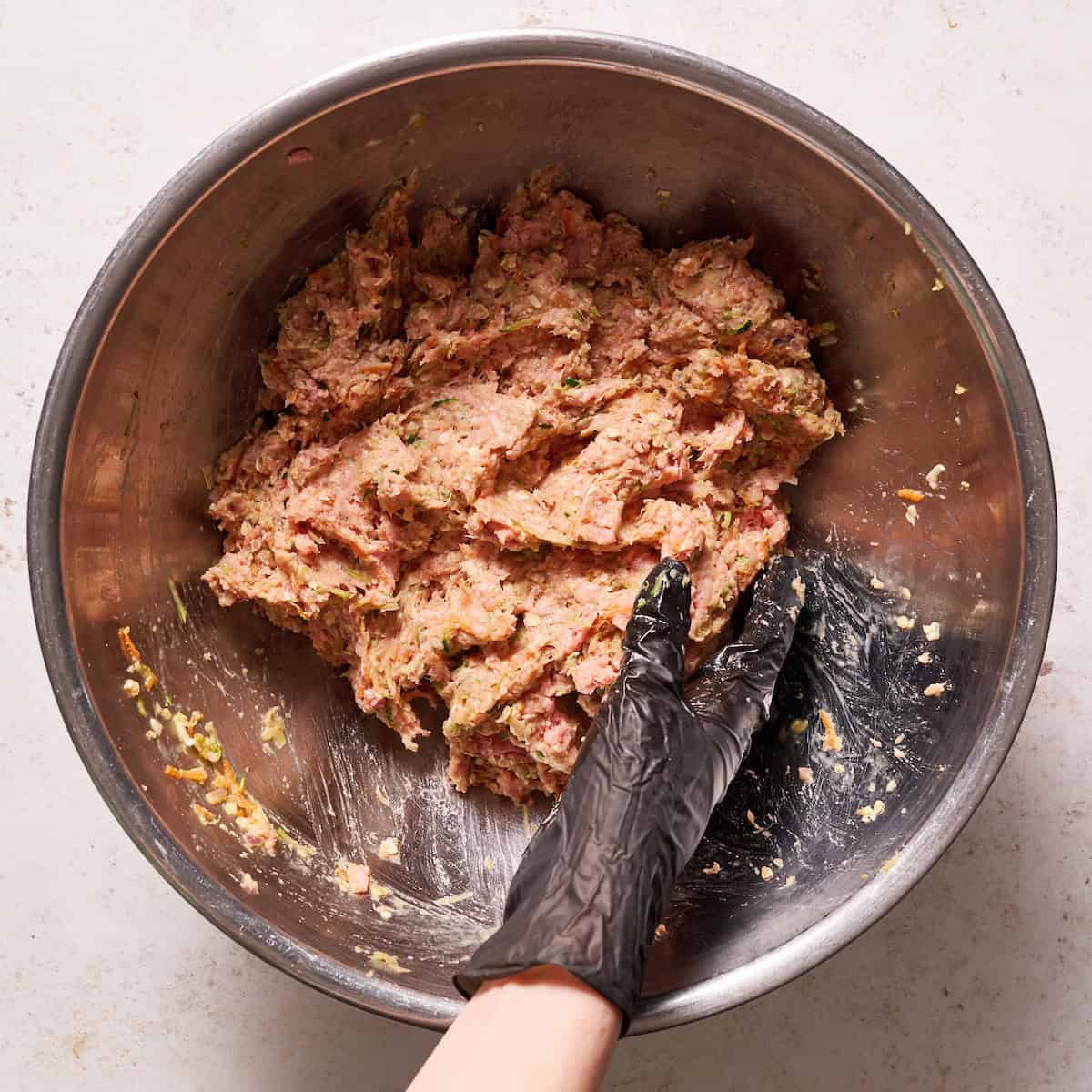 mixing the ingredients by hand gently to form the loaf