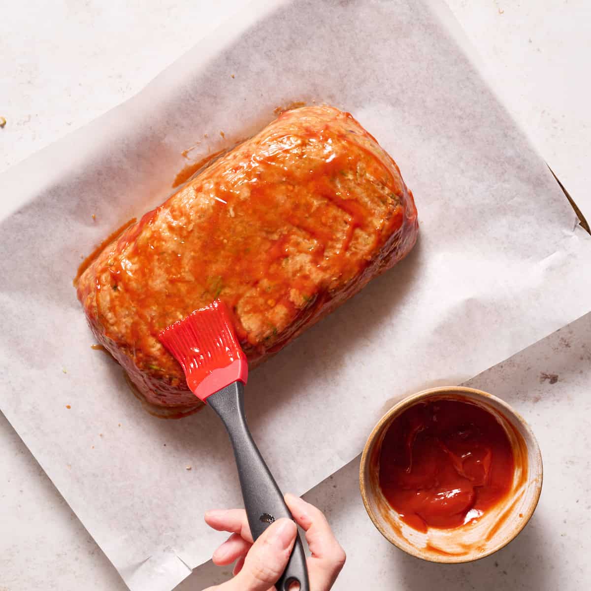 basting the meatloaf with ketchup