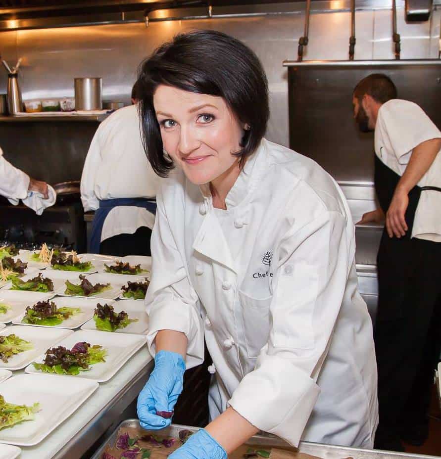 Joanie Simon of The Glucose Gourmet in a chefs coat at a restarant