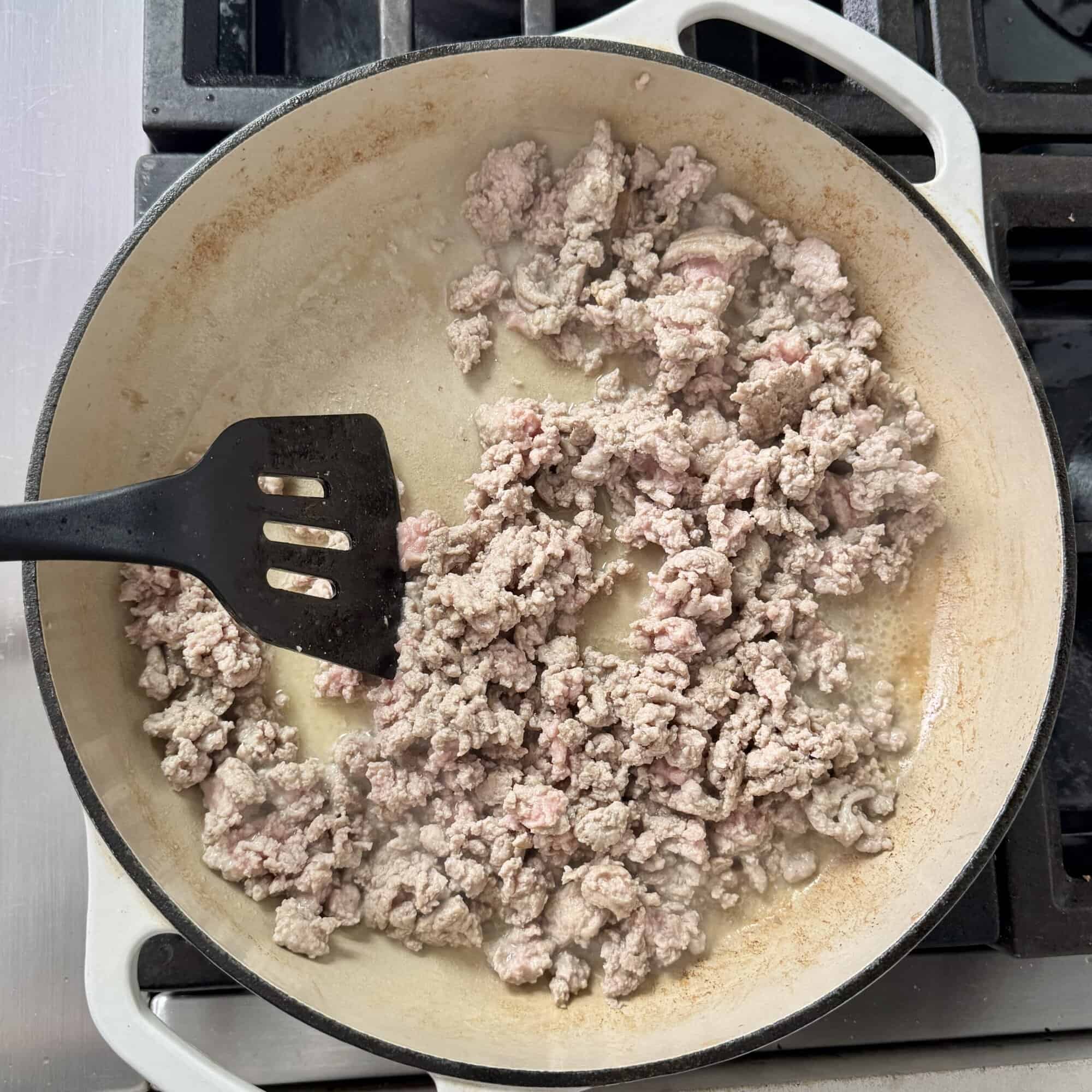 browning ground chicken in a skillet