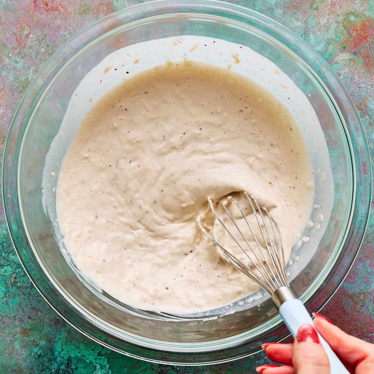 whisking greek yogurt caesar dressing