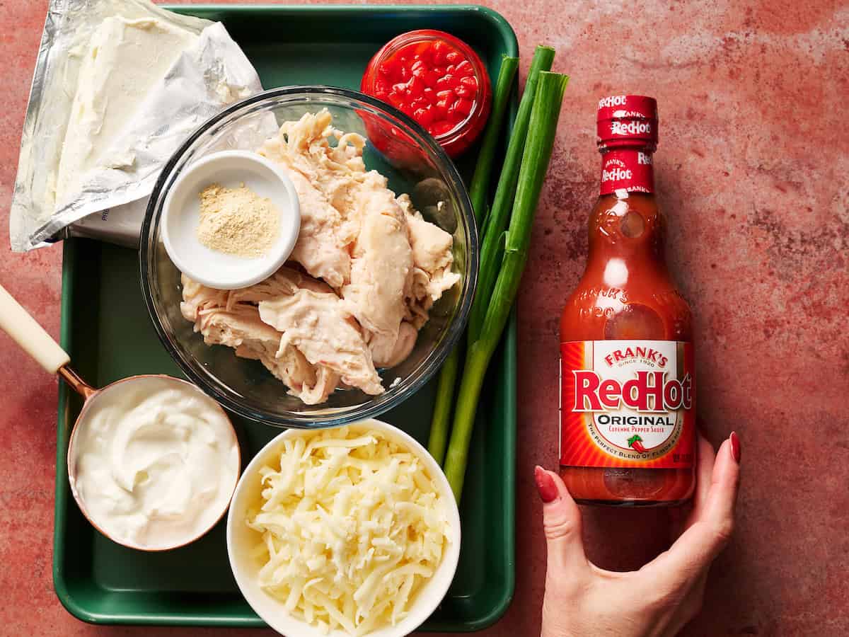 ingredients for making buffalo chicken dip including frank's red hot sauce