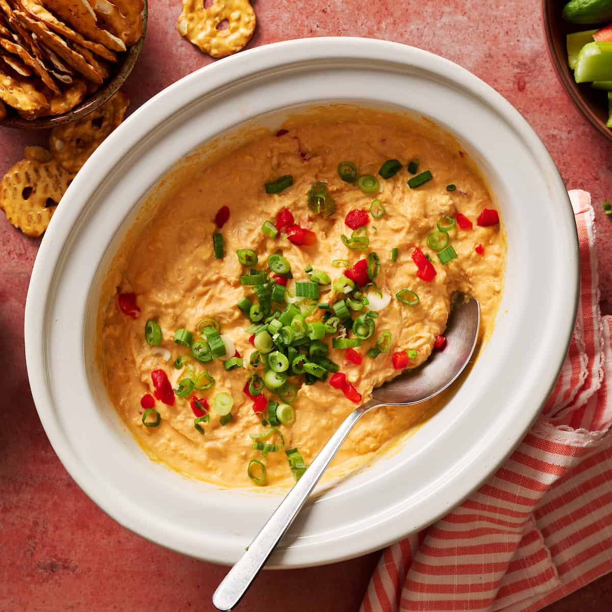 low-carb buffalo chicken dip in a crock pot topped with pimentos