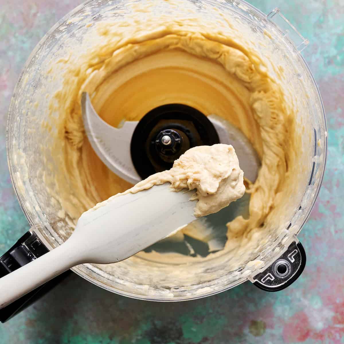 spoon of the lemon and tahini to show consistency