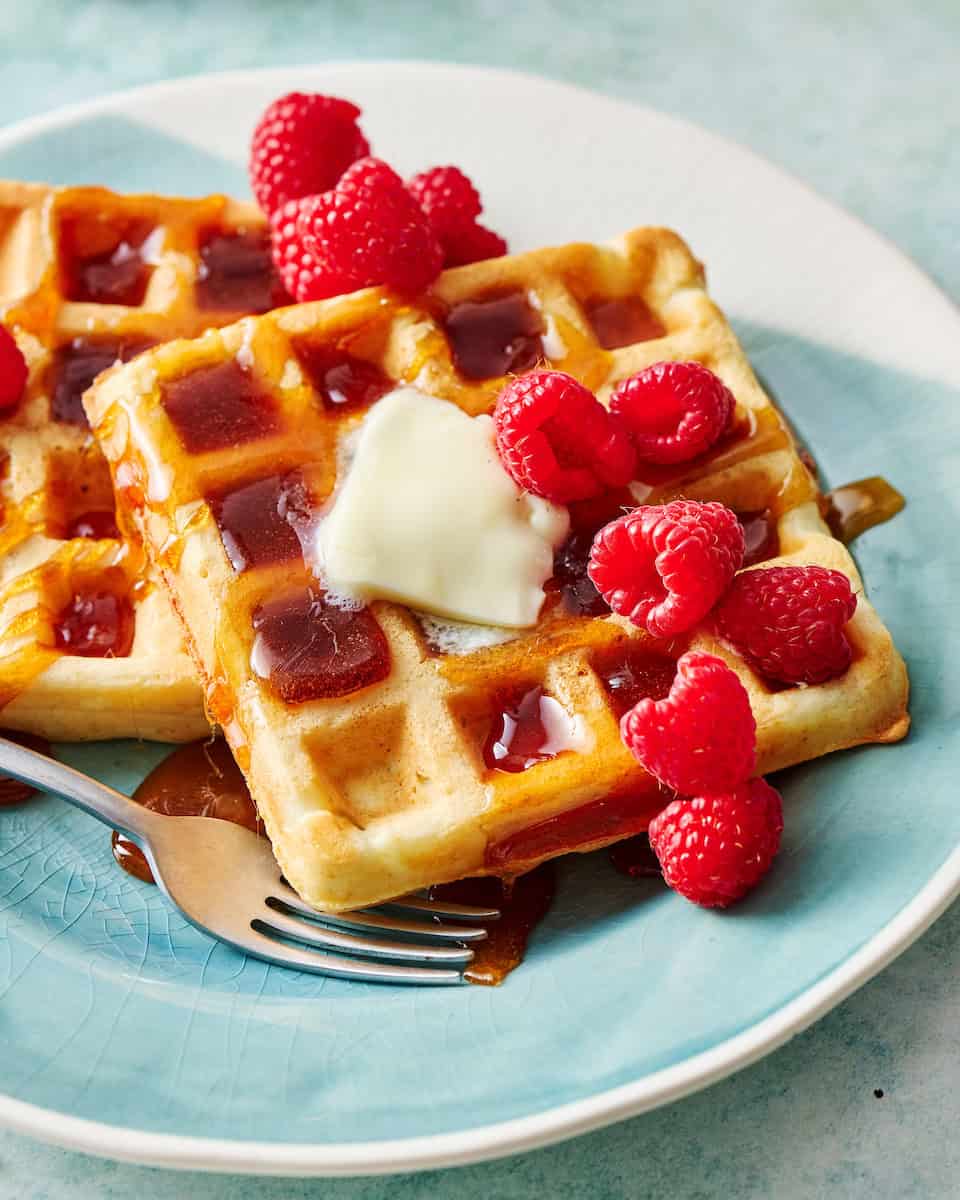 discard waffles topped with butter, syrup and berries