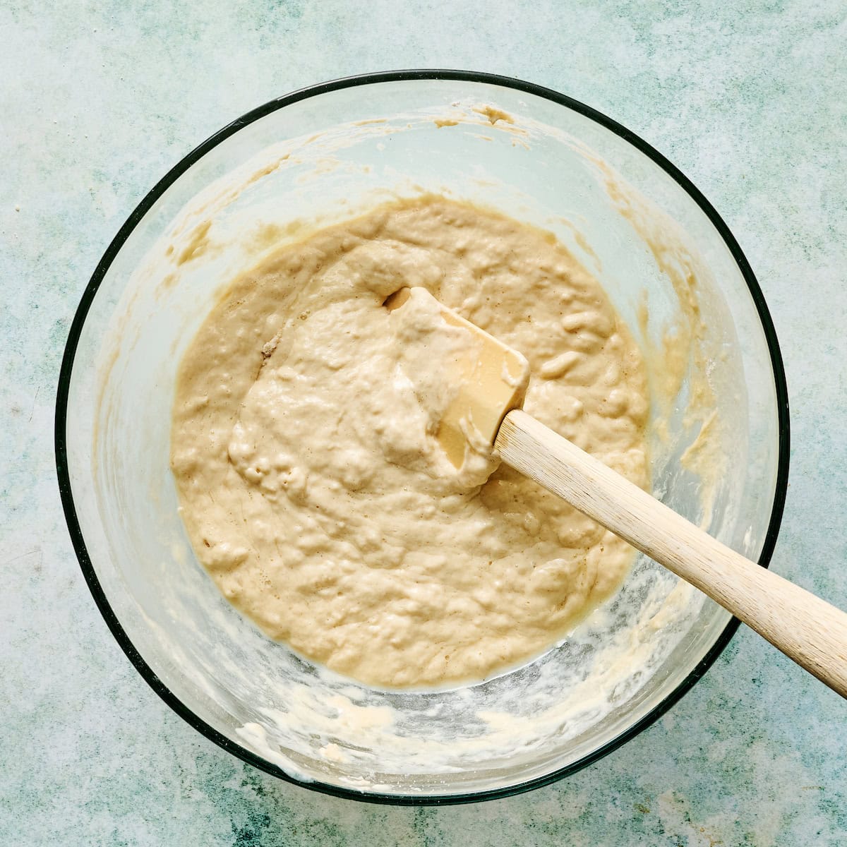 wet and dry ingredients folded together in a mixing bowl