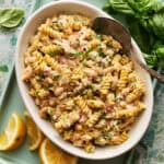 tuna pasta salad with lemon and basil on the side