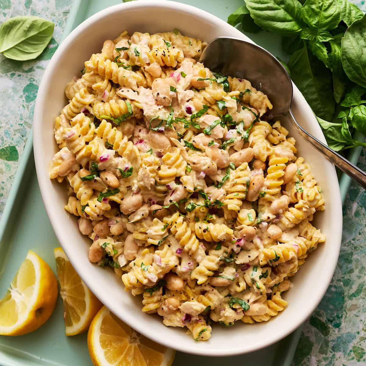 tuna pasta salad with lemon and basil on the side