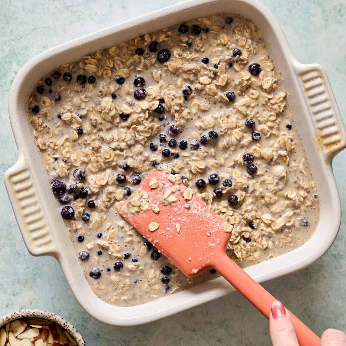 smoothing baked oatmeal into the pan before baking