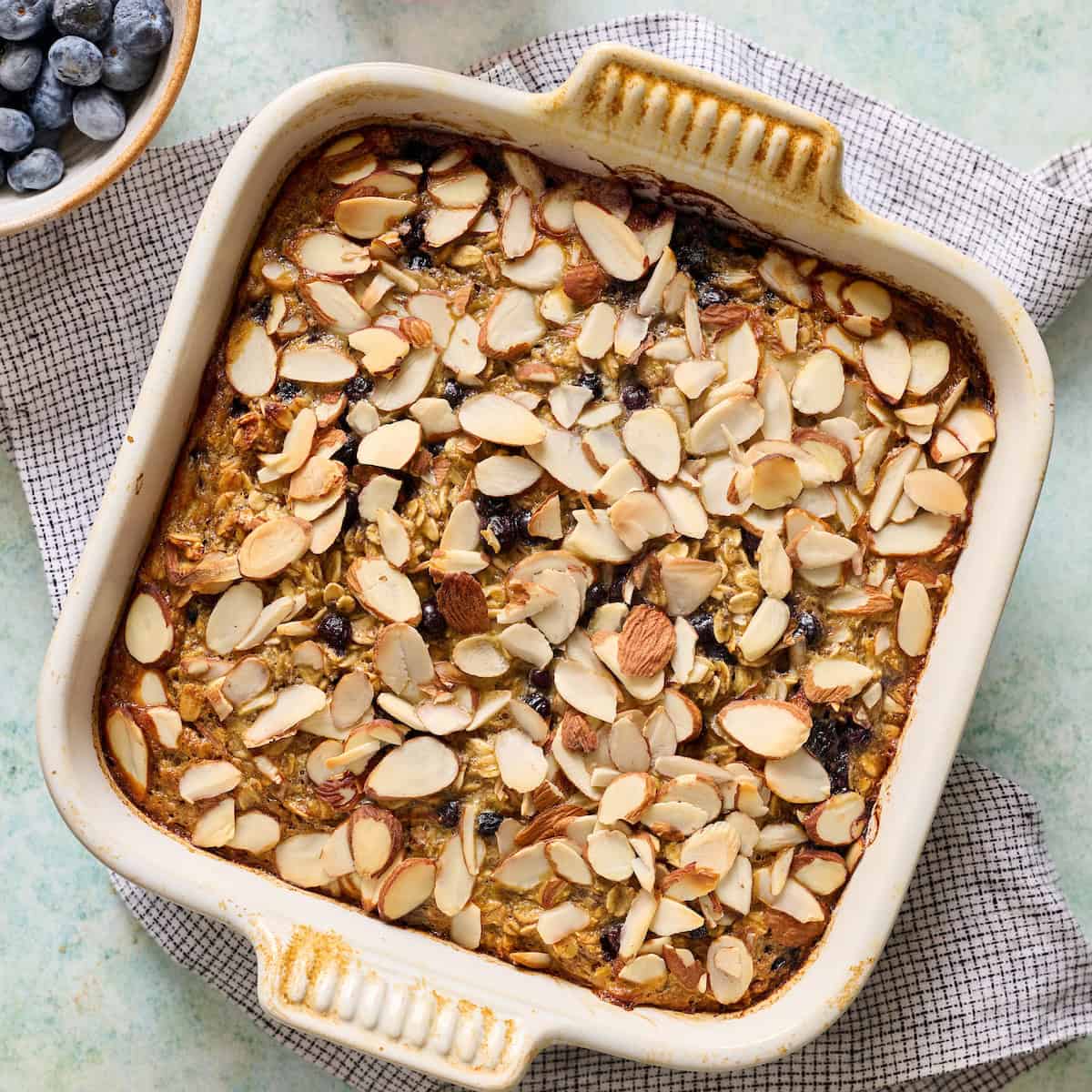 baked oatmeal fresh out of the oven topped with sliced almonds