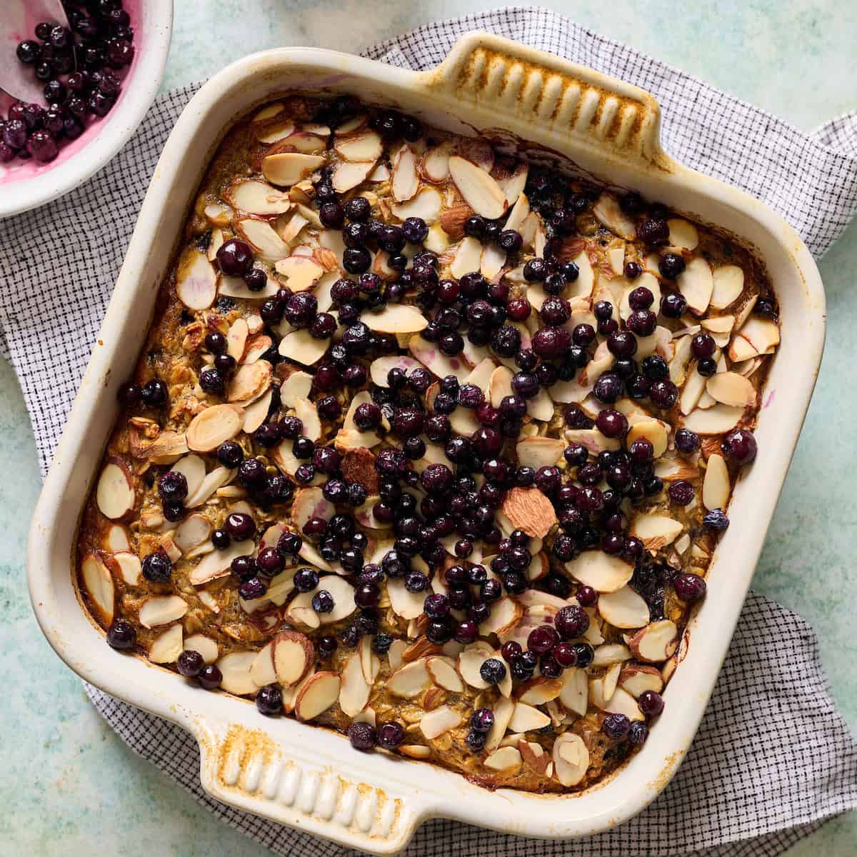 baked oatmeal topped with blueberries in a baking pan