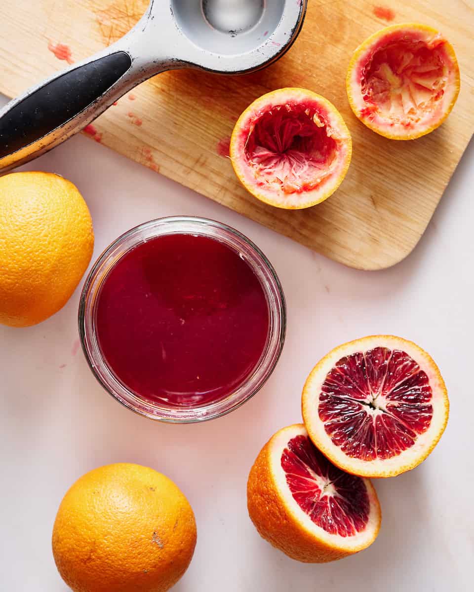 squeezing blood oranges for ruby red juice