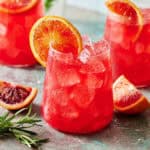 Glass of blood orange mocktail with ice and fresh sliced citrus