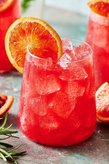 Glass of blood orange mocktail with ice and fresh sliced citrus