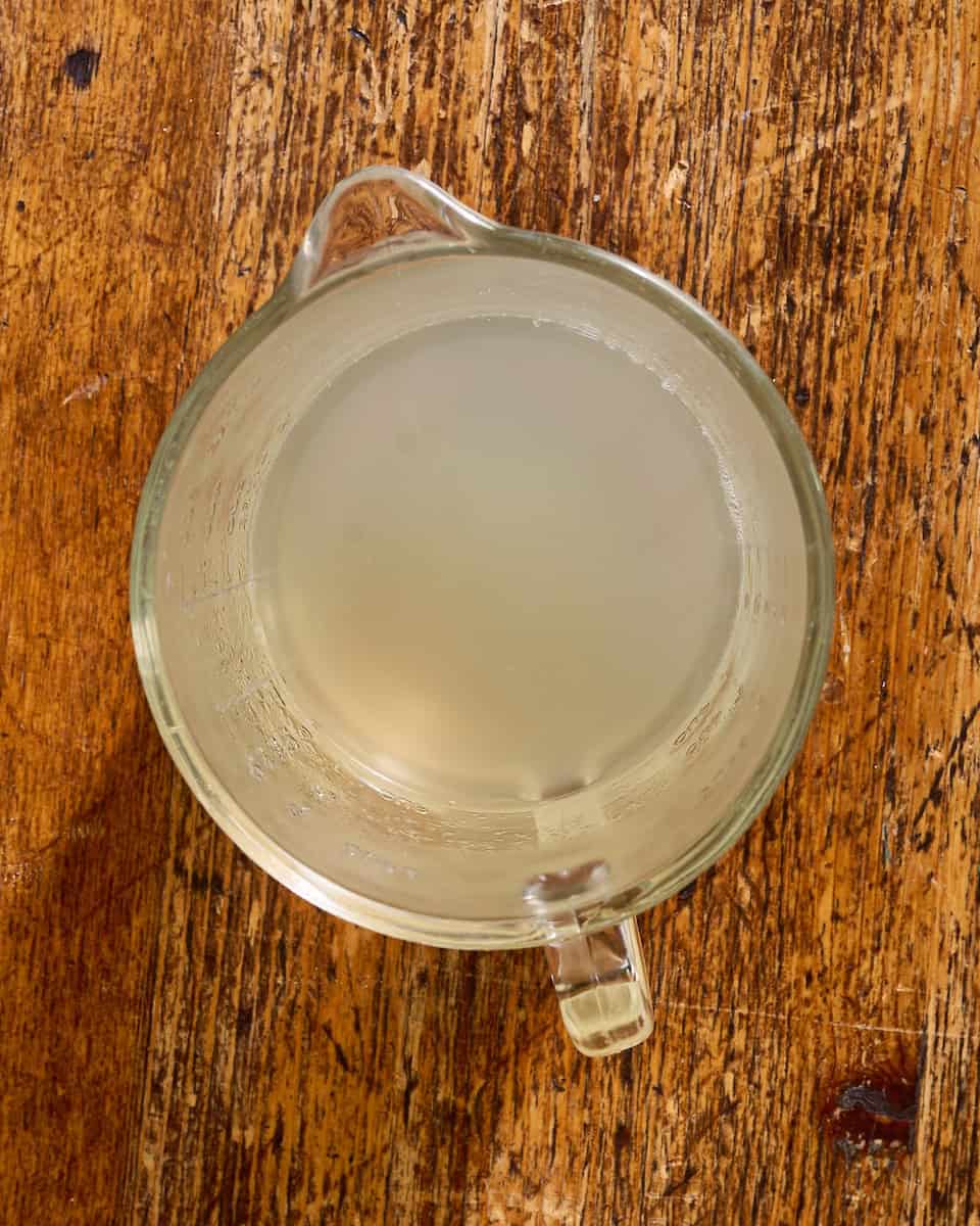 a cup of pasta water reserved after boiling the noodles