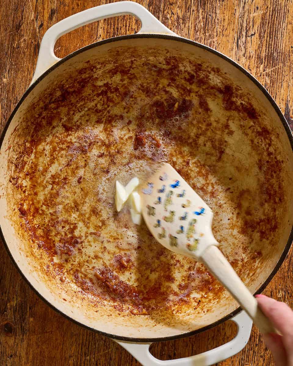 adding butter to the fond in the pan